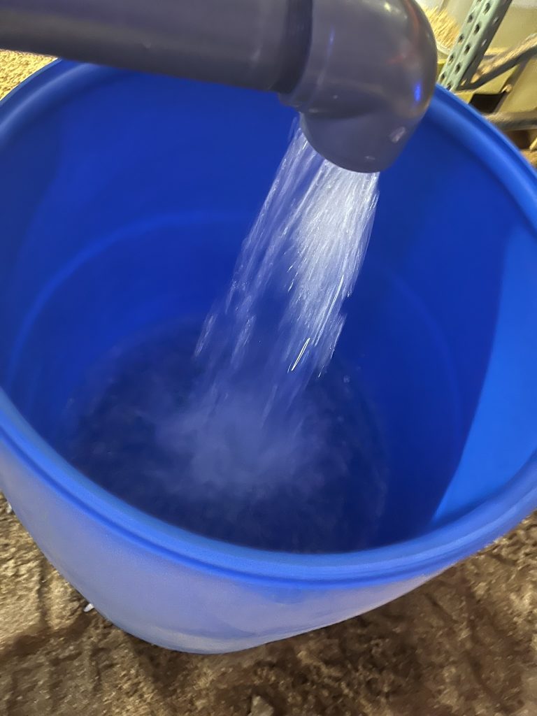 They transferred the remaining contents of the broken tote into two 55-gallon open top plastic drums as salvable product.