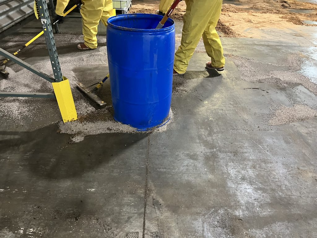 Oil dry and vermiculite were placed into seven 55-gallon open top plastic drums to be disposed of as waste.